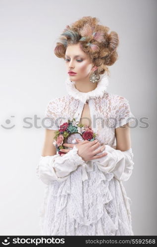 Personality. Luxurious Woman with Flowers in Evening Costume
