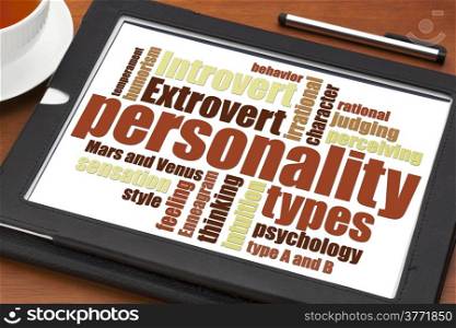 personality types word cloud on a digital tablet with a cup of tea