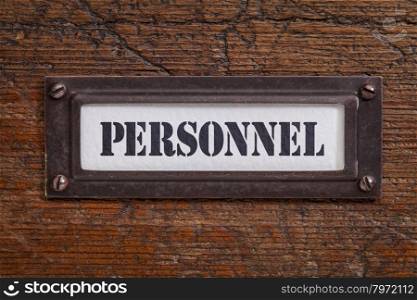 personnel - file cabinet label, bronze holder against grunge and scratched wood