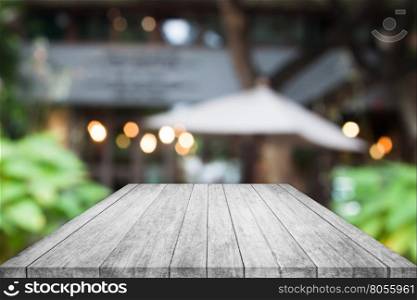 Perspective black and white wooden table top with cafe blurred abstract background