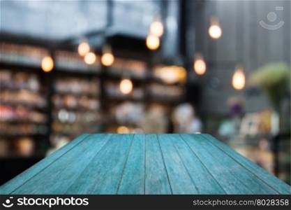 Perspective blue wooden on coffee shop blurred background with bokeh, stock photo