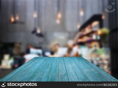 Perspective blue wooden with blurred background in coffee shop, stock photo