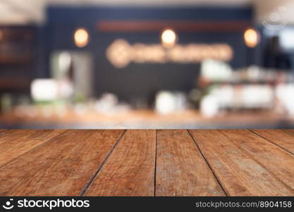 Perspective brown wood on blur cafe with light bulb background, stock photo