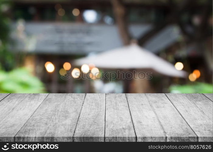 Perspective grey wooden table top with cafe blurred abstract background