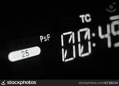 Perspective macro shot of the display of the professional hdcam video player. Shallow dof. Visible data: timecode, TC, 25 frames per second, PsF.