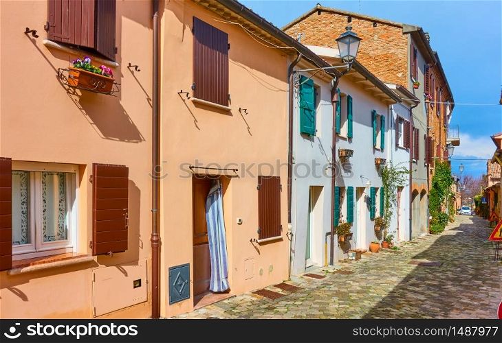 Perspective of an old cozy street with small colorful houses in Santarcangelo di Romagna town, Emilia-Romagna, Italy
