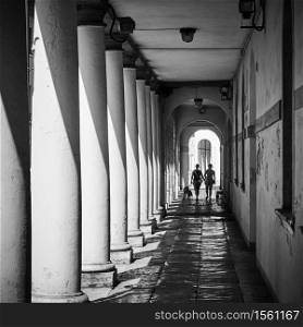 Perspective of covered gallery along a street in Treviso, Italy. Black and white urban photography. Shallow DOF!