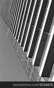 Perspective of many-storeyed apartment building. Black and white architectural photography