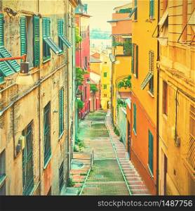 Perspective of old downhill street in Genoa, Italy. Vintage style toned image