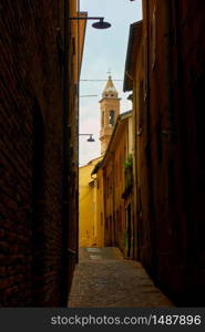 Perspective of old narrow street in Rimini, Italy