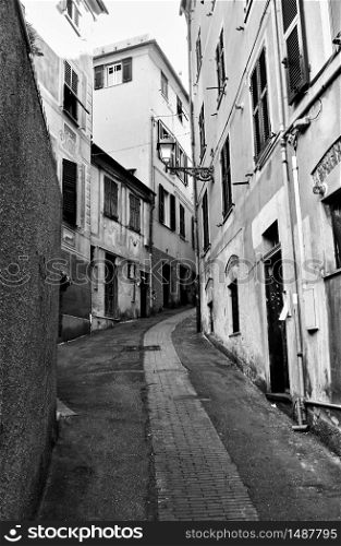 Perspective of old street in Genova Nervi town, Genoa, Italy. Wide angle black and white shot