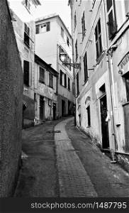 Perspective of old street in Genova Nervi town, Genoa, Italy. Wide angle black and white shot