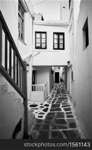 Perspective of old street in Mykonos town, Greece. Black and white architectural photography