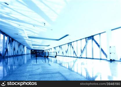 Perspective of the office corridor toned in blue color