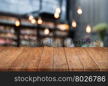 Perspective table top wooden with blurred cafe background. product display template