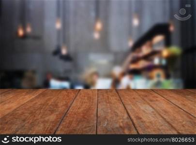 Perspective table top wooden with blurred coffee shop background. product display template