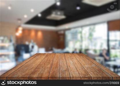 Perspective top brown wooden with blurred cafe interior for background. product display template