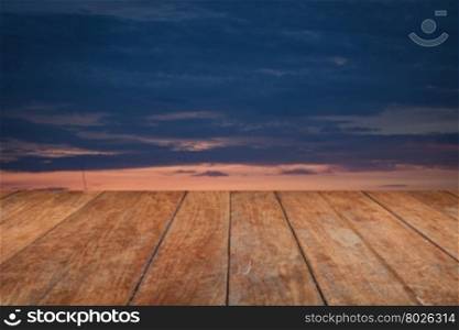 Perspective top wooden with sunrise on the lake with beautiful sky
