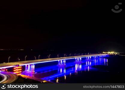 Perspective view of a bridge lit up at night. Barnaul City, Russia
