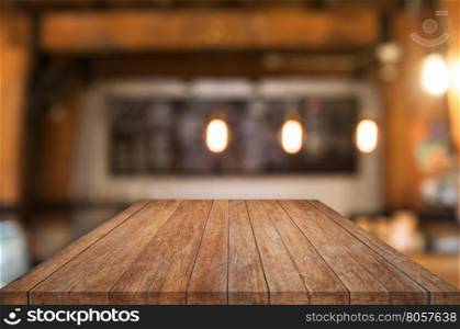 Perspective wooden table top with coffee shop blurred abstract background
