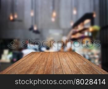 Perspective wooden with blurred background in coffee shop, stock photo