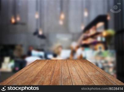 Perspective wooden with blurred background in coffee shop, stock photo