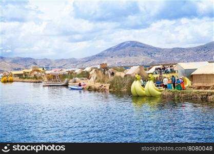 PERU - MAY 11, 2015: Unidentified women in traditional dresses welcome tourists in Uros Island