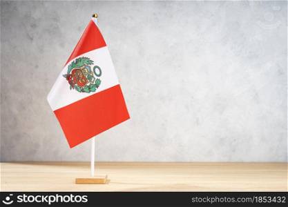 Peru table flag on white textured wall. Copy space for text, designs or drawings