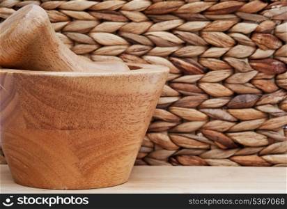 Pestle and mortar with basket weave background and shallow depth of field