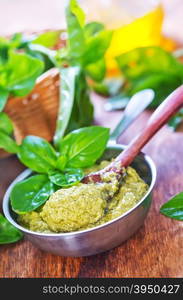 pesto sauce in bowl and on a table