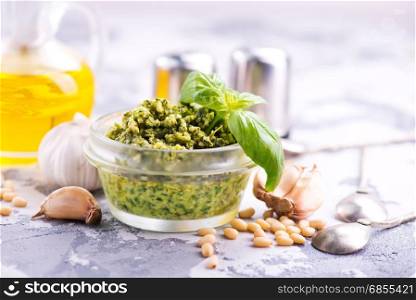 pesto sauce in glass and on a table