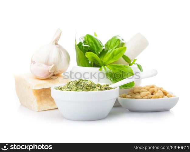Pesto sauce ingredients: fresh green basil, parmesan, pine nuts and garlic. On white