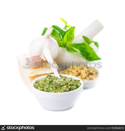 Pesto sauce ingredients: fresh green basil, parmesan, pine nuts and garlic. On white