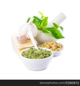 Pesto sauce ingredients: fresh green basil, parmesan, pine nuts and garlic. On white