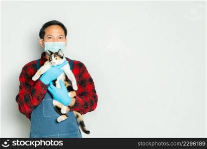 Pet owner affectionately holds a cat of 3 colors.