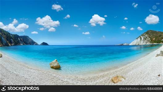 Petani Beach (Kefalonia, Greece). Summer coast panorama with blue cloudy sky. Two shots stitch image.