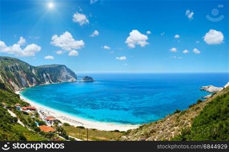Petani Beach summer panorama (Kefalonia, Greece). Deep blue sky with some cumulus clouds and sunshine. All people are not recognize.