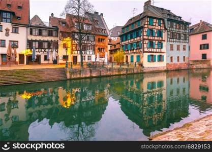 Petite France in the morning, Strasbourg, Alsace. Traditional Alsatian half-timbered houses with mirror reflections in Petite France in the morning, Strasbourg, Alsace, France