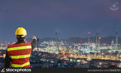 Petrochemical engineering man with white safety helmet standing in oil refinery building structure petrochemical industry
