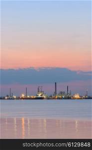 Petrochemical refinery at sea at sunset