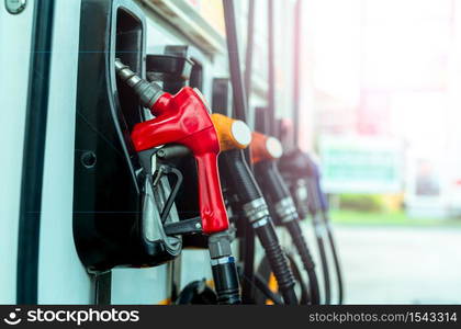 Petrol pump filling fuel nozzle in gas station. Fuel dispenser machine. Refuel fill up with petrol gasoline. Petrol industry and service. Red petrol fuel nozzle. Petroleum oil industry. Oil crisis.