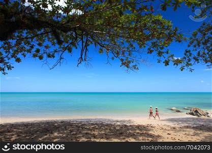 PHANG NGA, THAILAND - FEBRUARY 14: Tourist is walking along beach in the morning at Khaolak beach on the February 14, 2013 in Phang Nga, Thailand