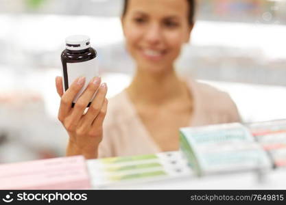 pharmaceutics, healthcare and people concept - close up of female customer choosing medicine at pharmacy. close up of customer choosing medicine at pharmacy