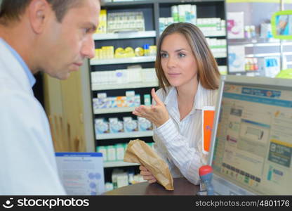 pharmacist and client at pharmacy