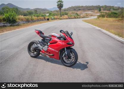 Phetchaburi, Thailand - April 14, 2016: Beautiful red Ducati 899 motorbike, photographed outdoor on a cloudy day. Red super bike Ducati 899, &#xA;it is a V-twin Desmodromic valve actuated engine sport &#xA;bike by Ducati Motor Holding.