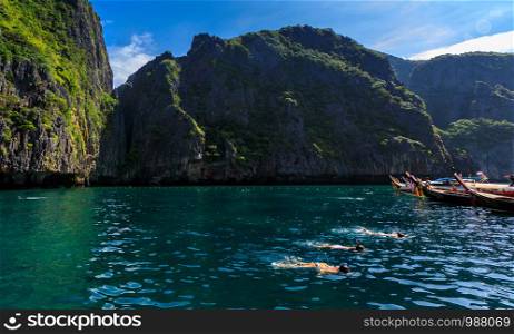 phi phi is land Thailand December 6,2018 long tail boat take foreign tourists to see phi phi island and snorkelling kra bi Thailand