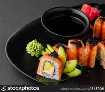 Philadelphia sushi with avocado on black plate