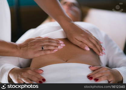 Philippine Psychic Surgery Healer Doing Treatment with Female Patient. Holding her Hands Above Patient’s Stomach. Philippine Psychic Surgery Treatment