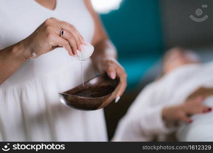 Philippine Psychic Surgery Healer Preparing for Treatment. Using Cotton Ball and Water in Wooden Bowl.. Philippine Psychic Surgery