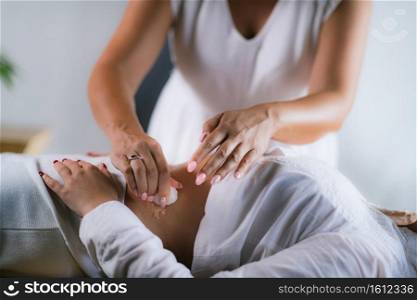 Philippine Psychic Surgery Healer Working with Female Patient, Placing Wet Cotton Ball on her Stomach.. Spiritual Healer Using Cotton Balls and Water for Philippine Psychic Surgery Treatment